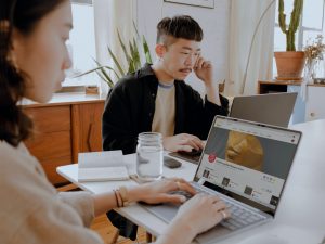 2 people sitting at table working