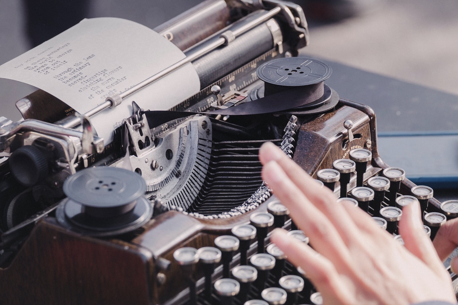 person typing using typewriter