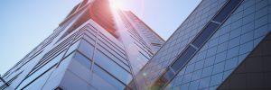 low-angle photography of blue glass walled buildings under blue and white sky