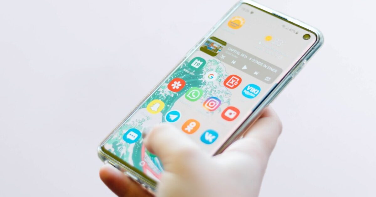 person using silver Android smartphone