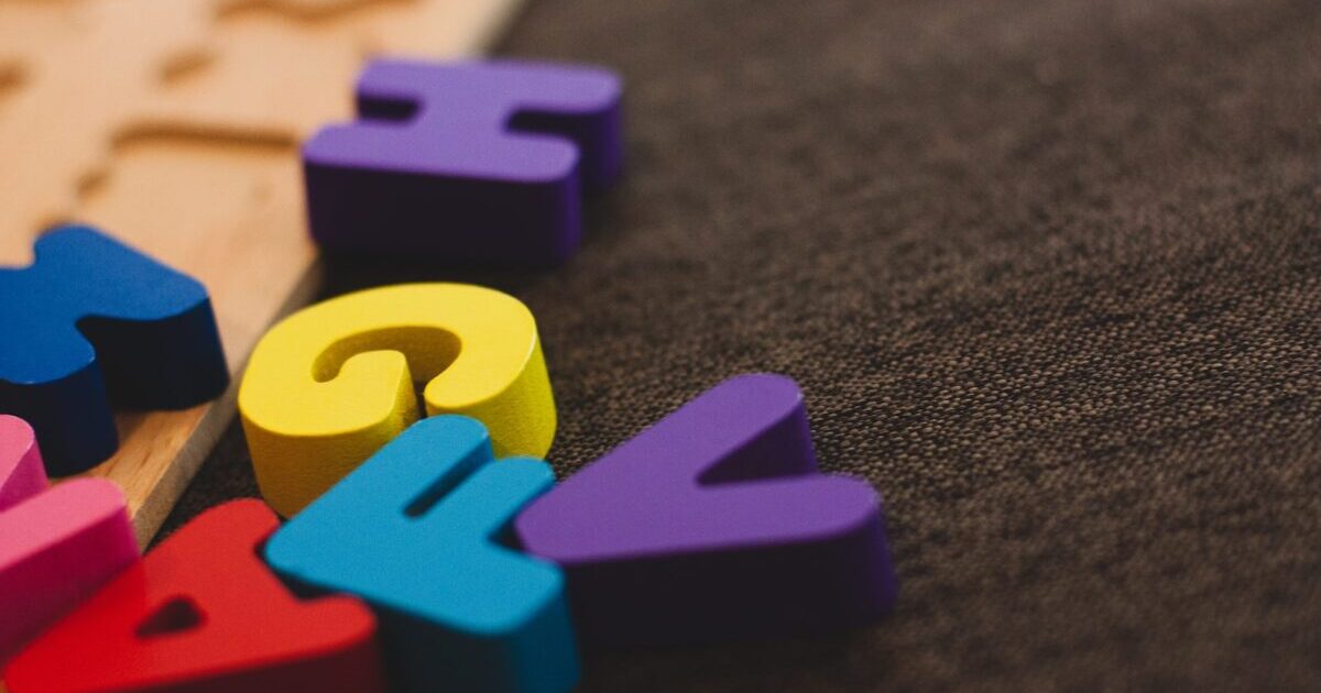 alphabet learning toy on gray apparel